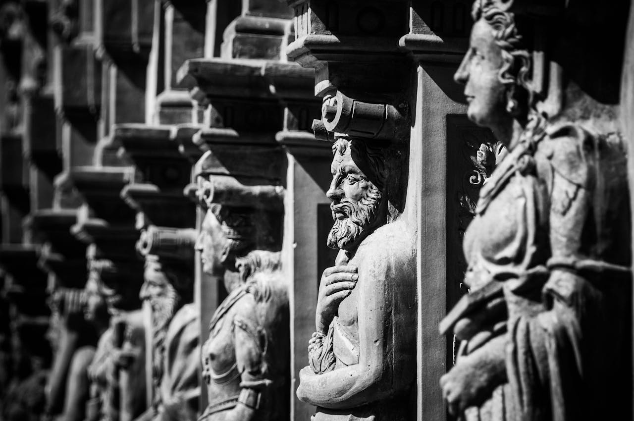 About Black and white photo of historic stone sculptures showcasing intricate craftsmanship.