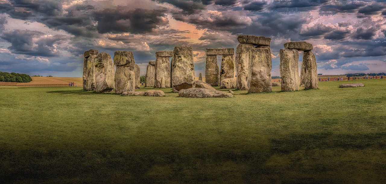 About Panoramic view of Stonehenge with dramatic clouds in Wiltshire, England. Iconic prehistoric monument.